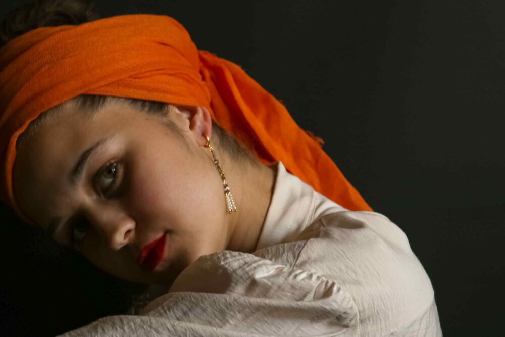 Girl with the earring wearing orange scarf