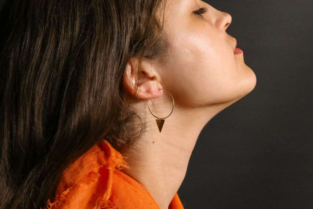 girl in orange triangle hoops earrings